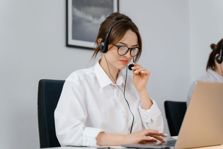 Photo by MART PRODUCTION: https://www.pexels.com/photo/photo-of-a-woman-in-a-white-shirt-holding-the-microphone-on-her-headset-7709208/